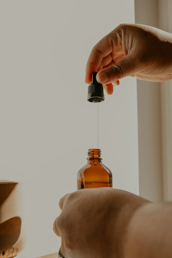 Amber dropper bottle with liquid supplement on a wooden surface